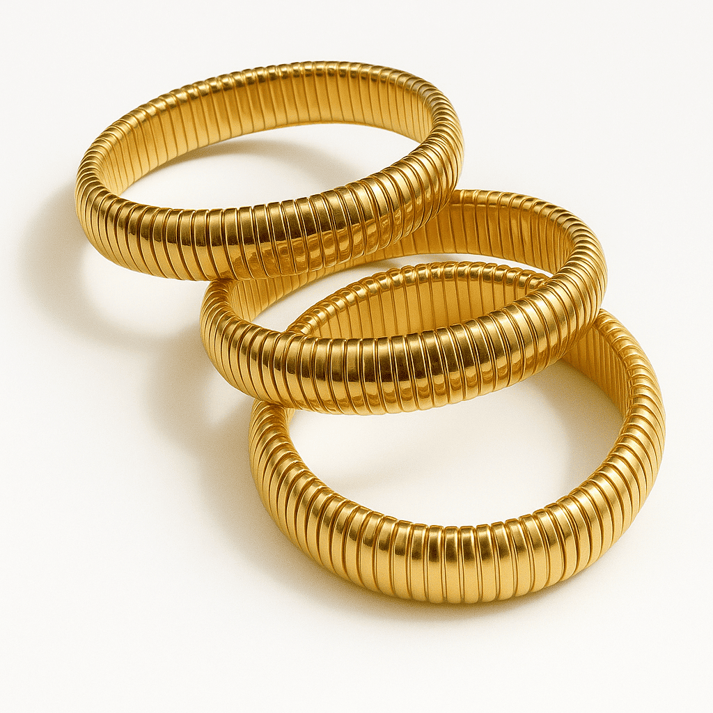 Close-up detail of a gold ribbed bangle bracelet with modern texture
