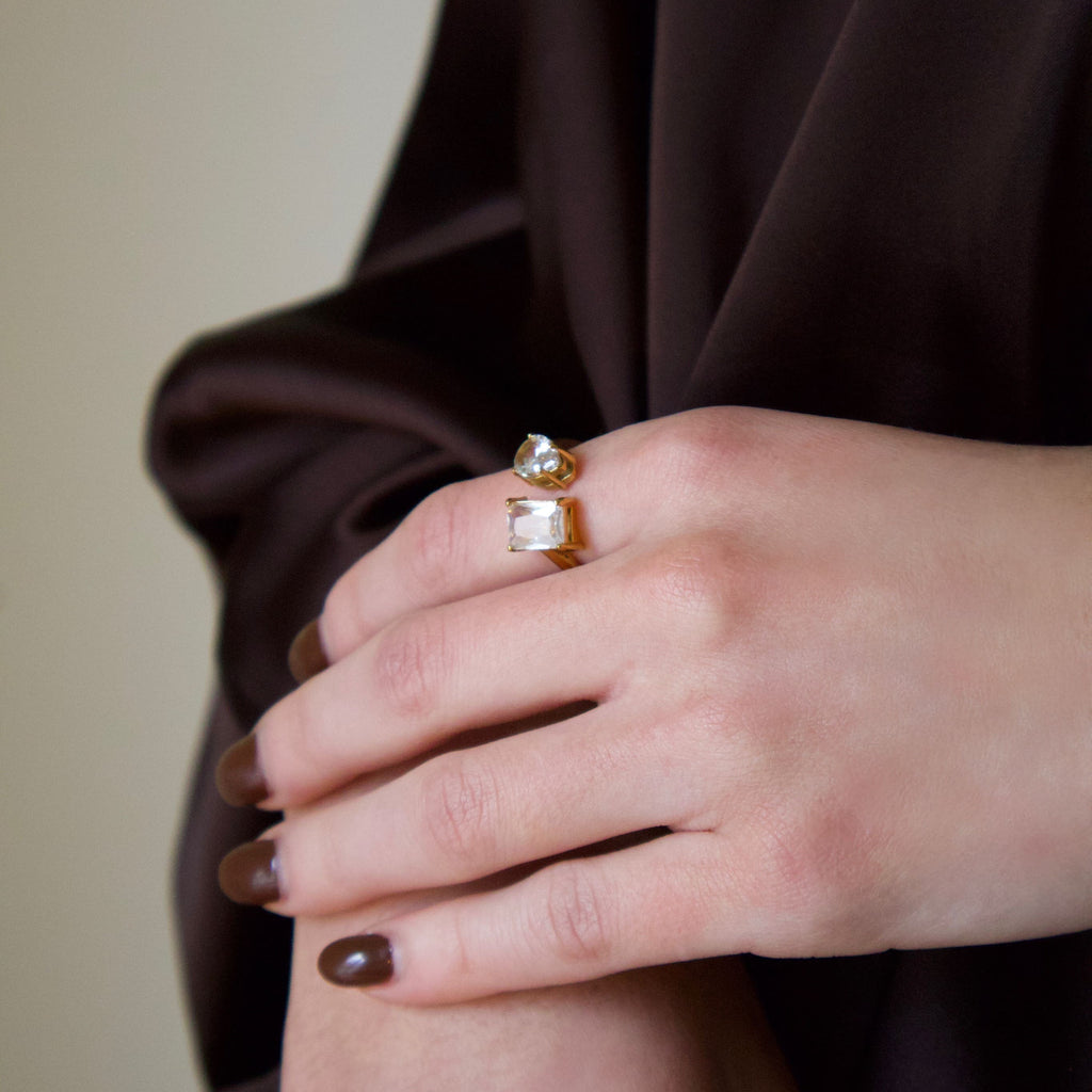 Model wearing a gold crystal statement ring with a contemporary sculptural design
