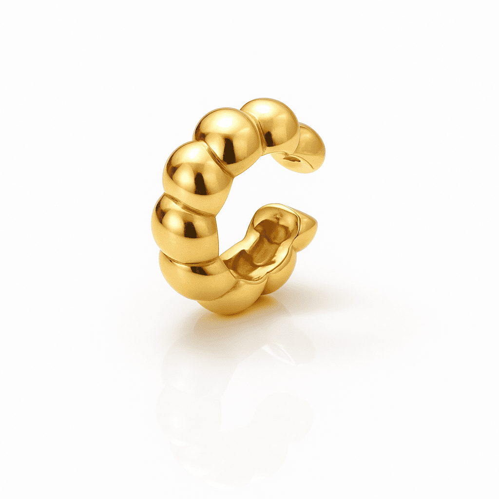 Beaded gold ear cuff with rounded dome design and high-polish finish, made of stainless steel, displayed on a white background.