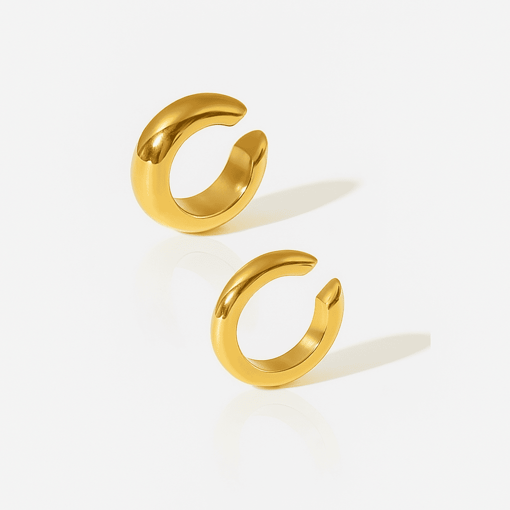 Set of two bold dome gold ear cuffs with smooth polished finish, minimalist stainless-steel jewelry on a white background.