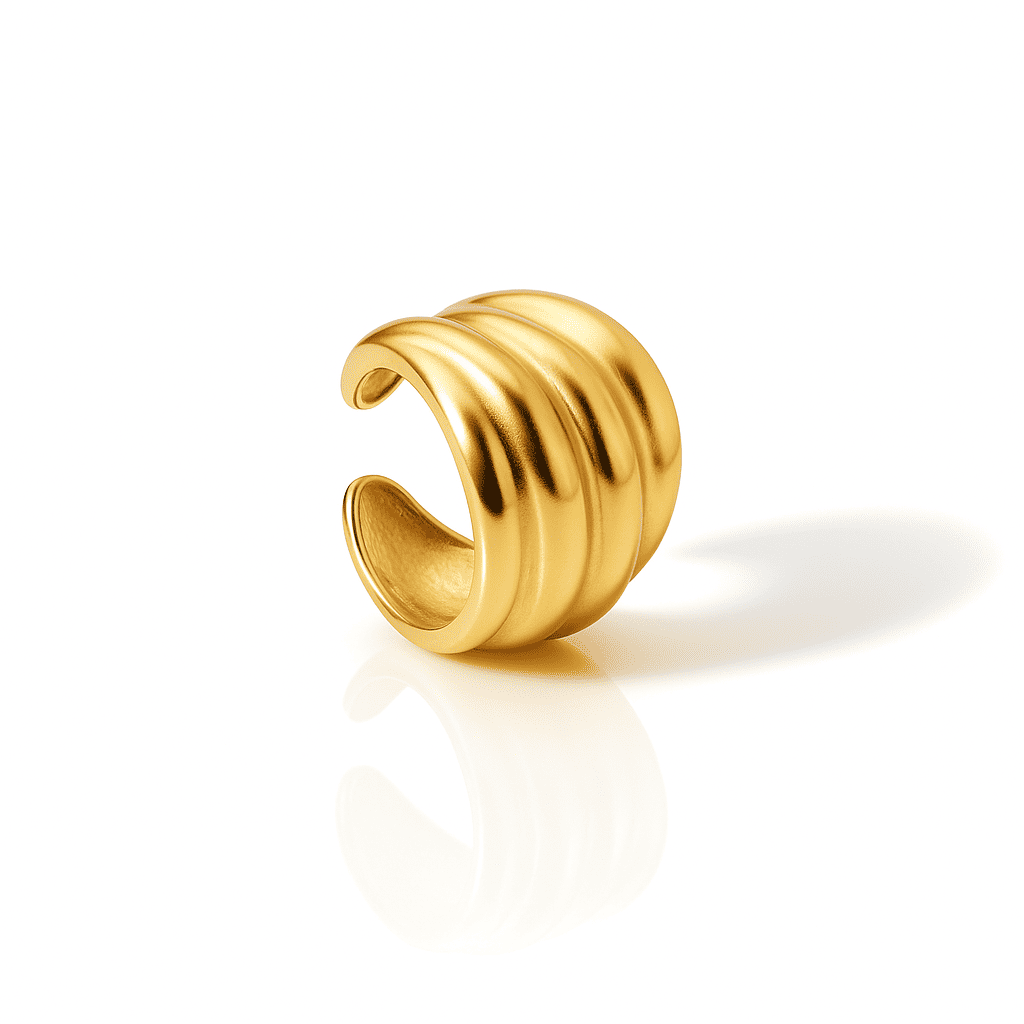 Bold ridged gold ear cuff with sculpted dome design and polished satin finish, modern stainless steel jewelry on a white background.