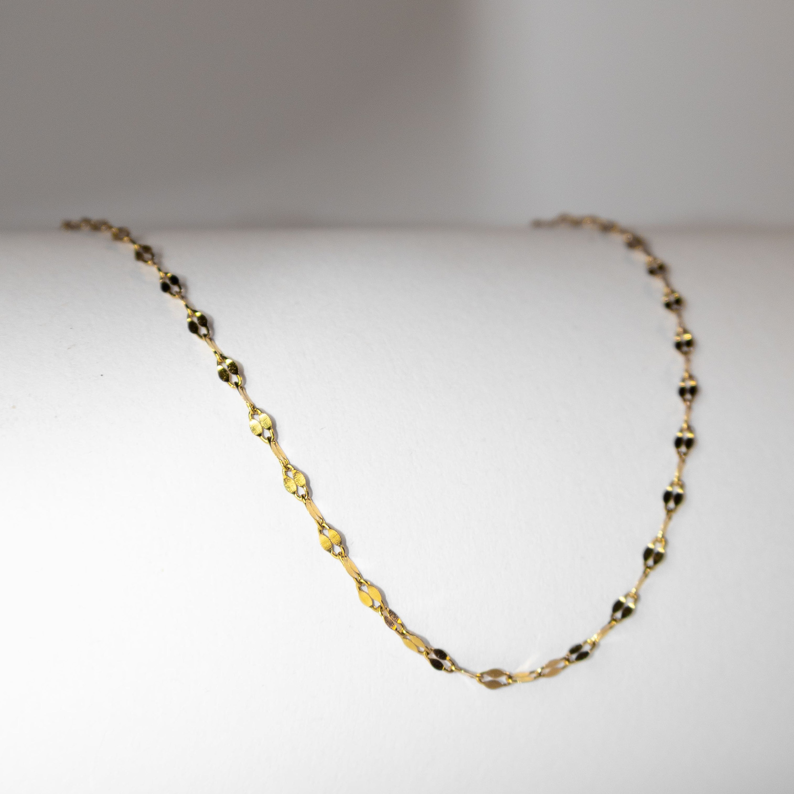 shimmer gold chain necklace, reflective finish