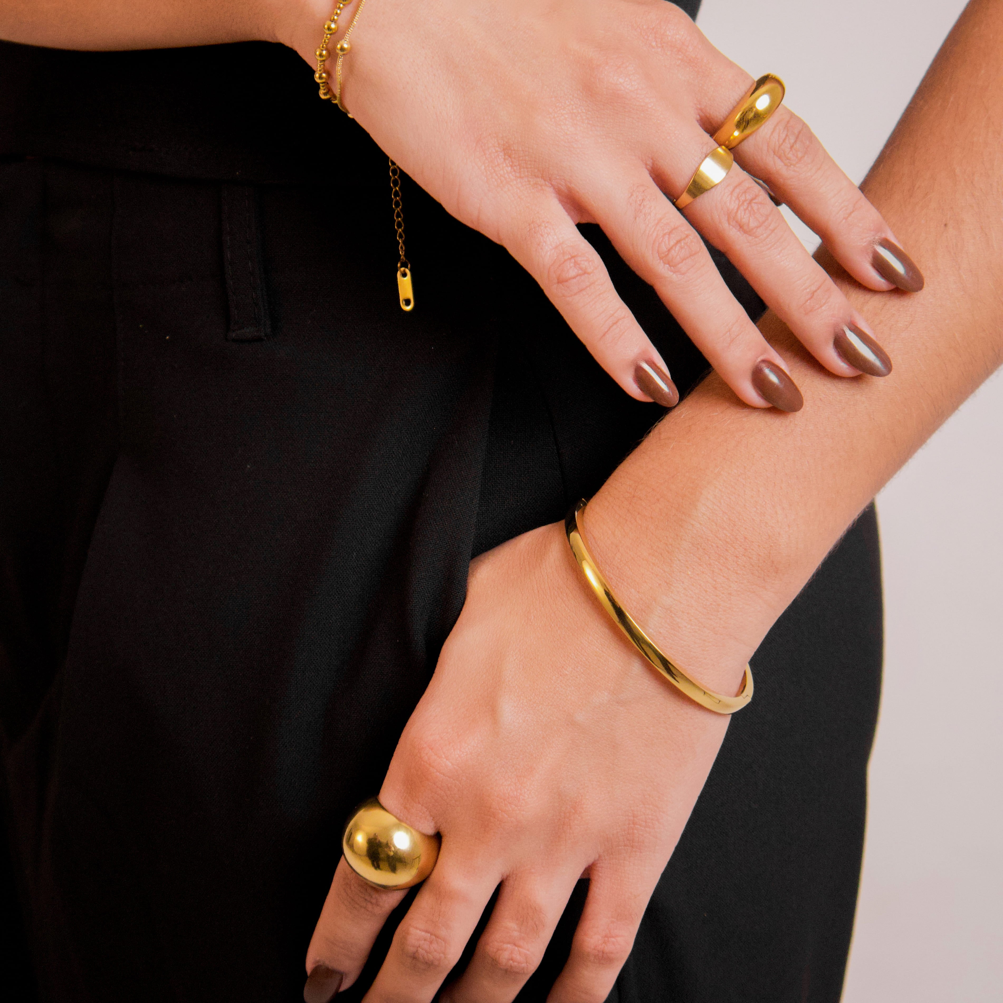 Minimalist gold sphere ring with a polished stainless steel finish