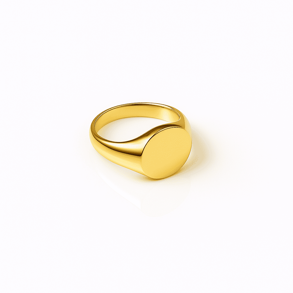 Minimalist gold signet ring with a smooth round top and polished stainless steel finish on a white background.