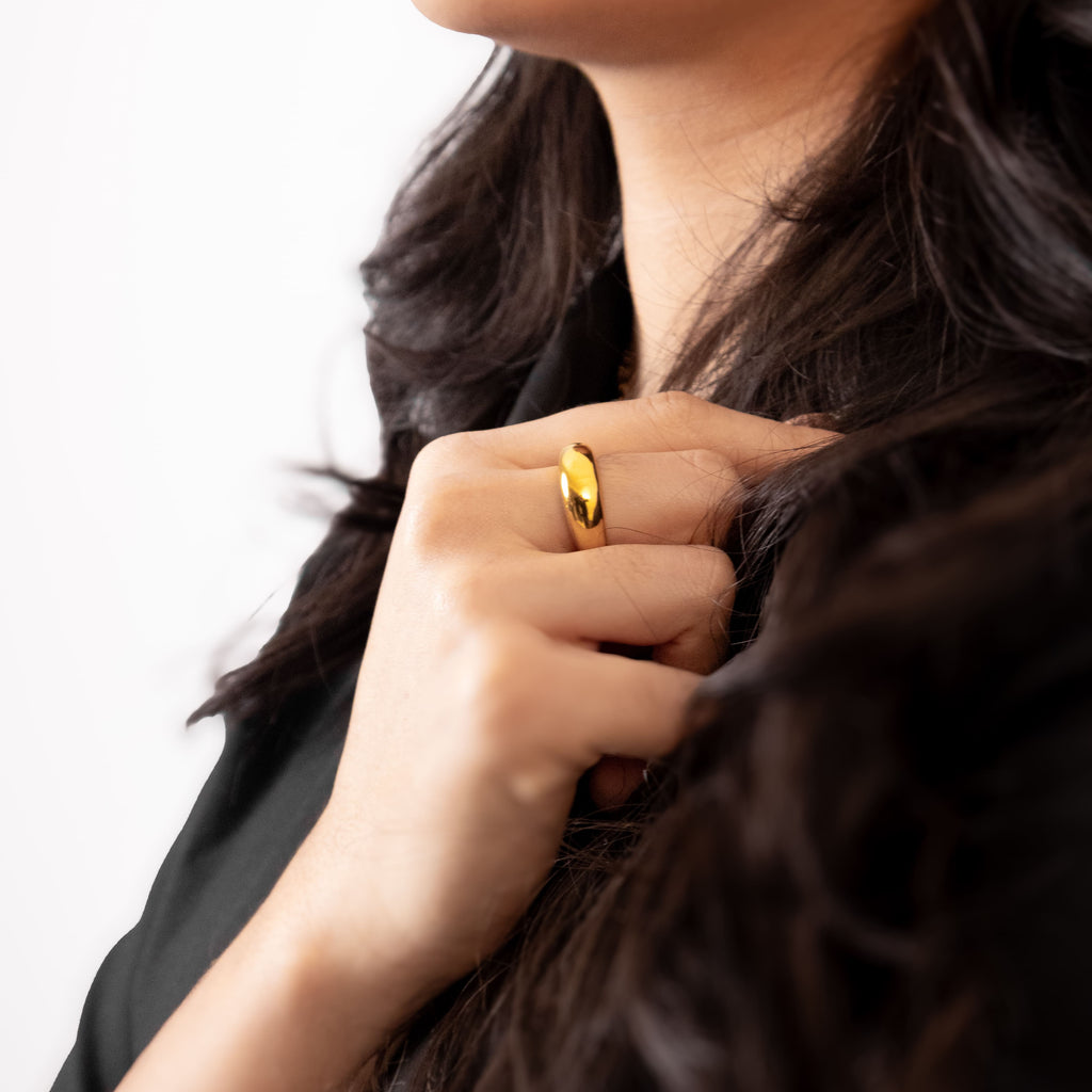 Minimalist gold ring with a smooth drop-shaped design