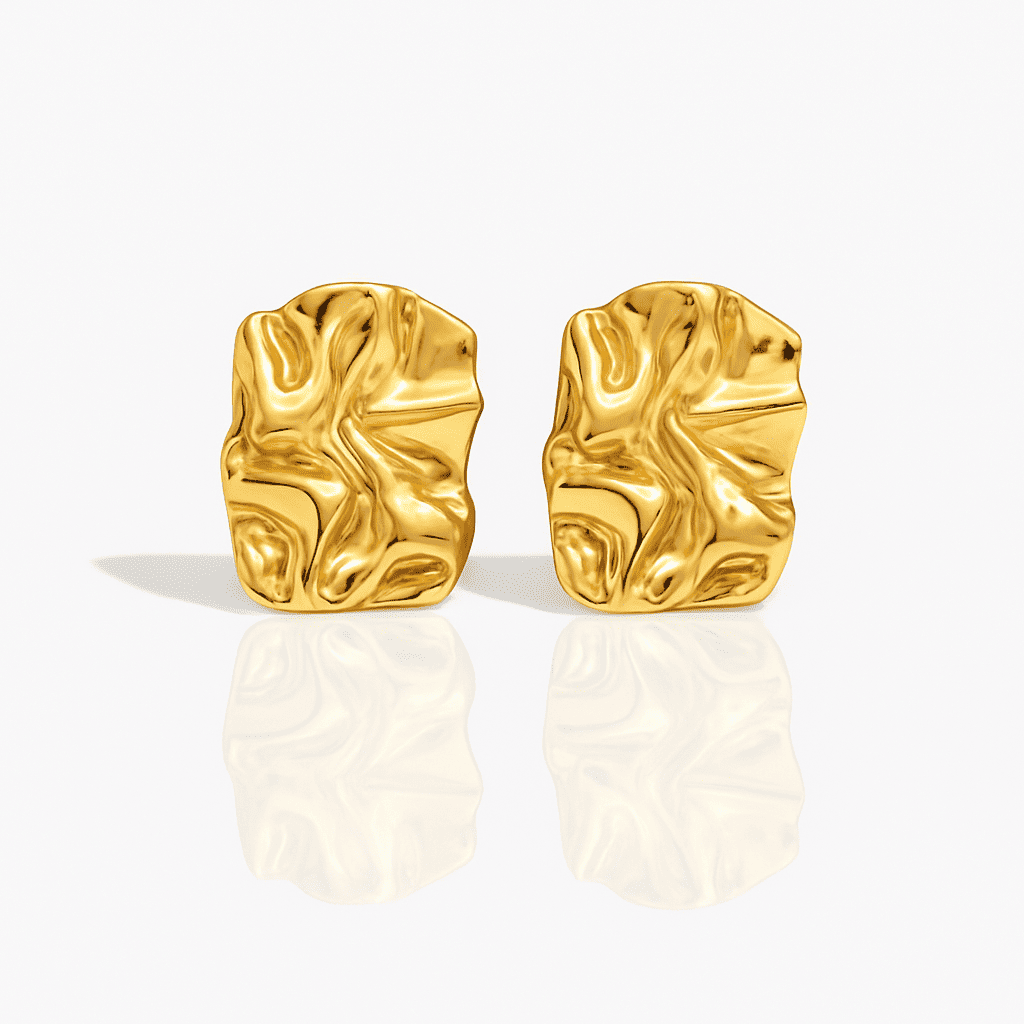 Organic gold statement earrings with fluid textured surface and reflective finish, made of stainless steel, displayed on a white background.