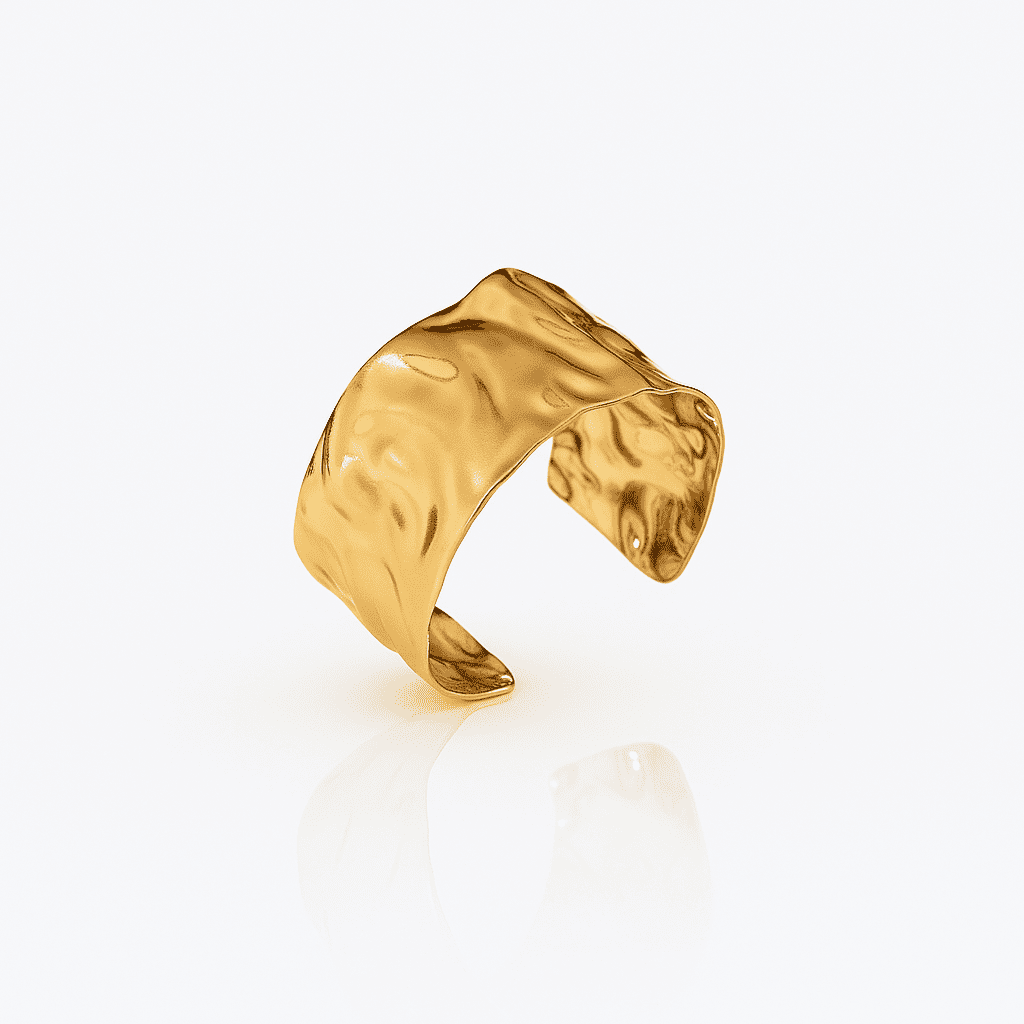 Organic textured gold cuff bracelet with sculptural, fluid surface and polished finish, modern statement jewelry piece on a white background.
