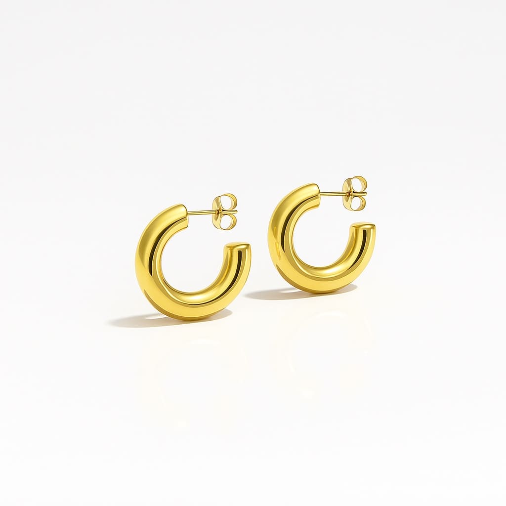 Minimalist thick gold hoop earrings with a smooth polished finish, modern luxury jewelry on a white background.